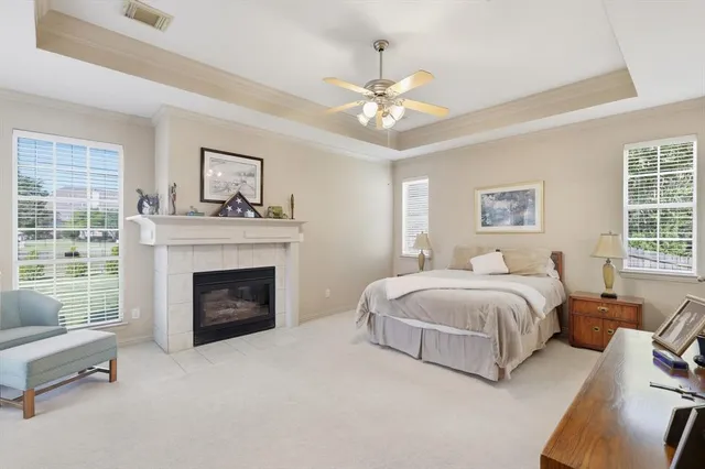 a spacious bedroom with a bed and a fireplace