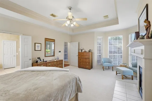 a bedroom with furniture and large windows