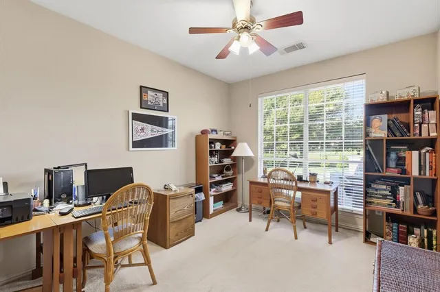 a view of a workspace with furniture and a bookshelf