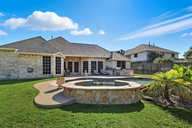 a view of a house with swimming pool and a yard