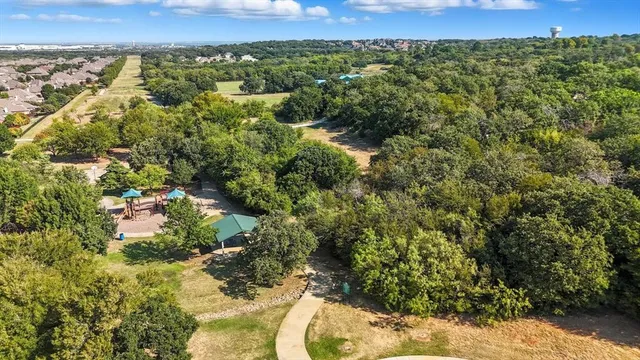an aerial view of a houses with a yard