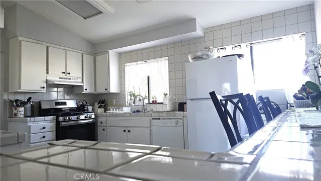 a large bed sitting in a bedroom next to a window and a mirror