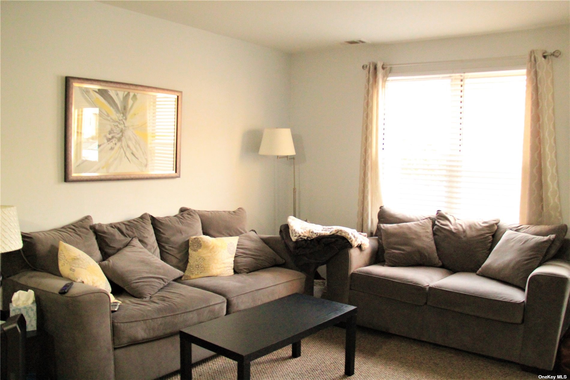 63 Rocky Point Yaphank Road, Unit 84 Rocky Point, NY 11778 - Photo 1 of 1 a living room with furniture and a window