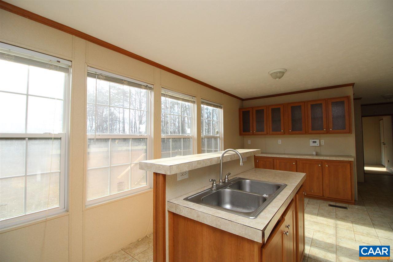 8568 Venable Road Kents Store, VA 23084 - Photo 4 of 11 a kitchen with stainless steel appliances granite countertop a sink and a large window