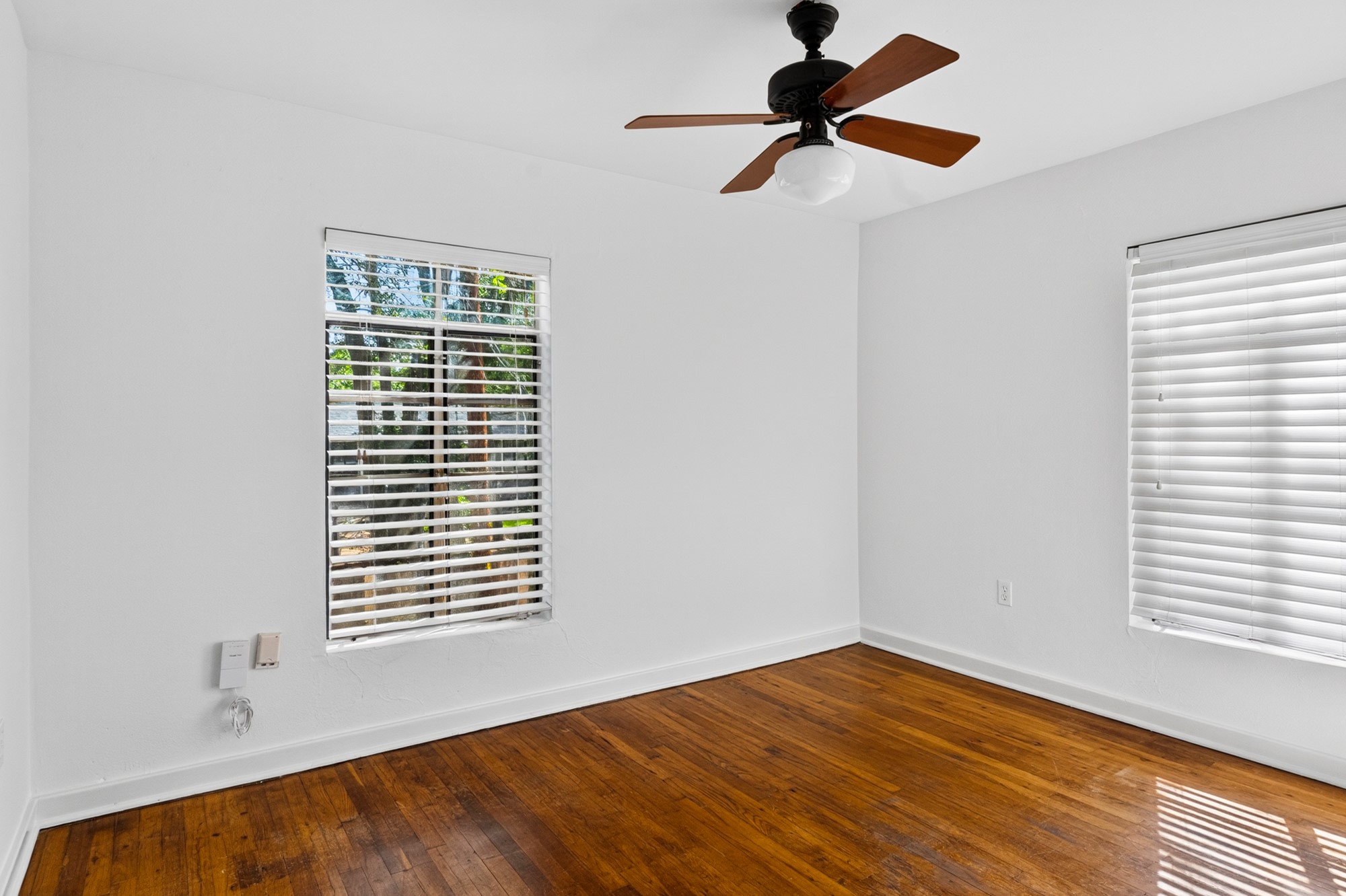 1302 Kirkwood Road, Unit B Austin, TX 78722 - Photo 17 of 21 Rich hardwood floors complement the natural light streaming into this inviting room.
