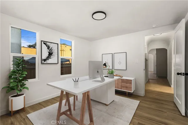 a room with furniture a potted plant and a table