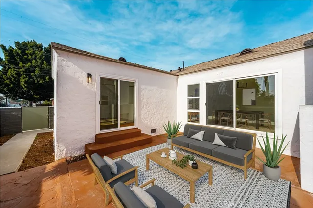 a balcony with furniture and a potted plant