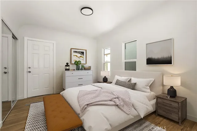 a bedroom with a bed and a flat screen tv