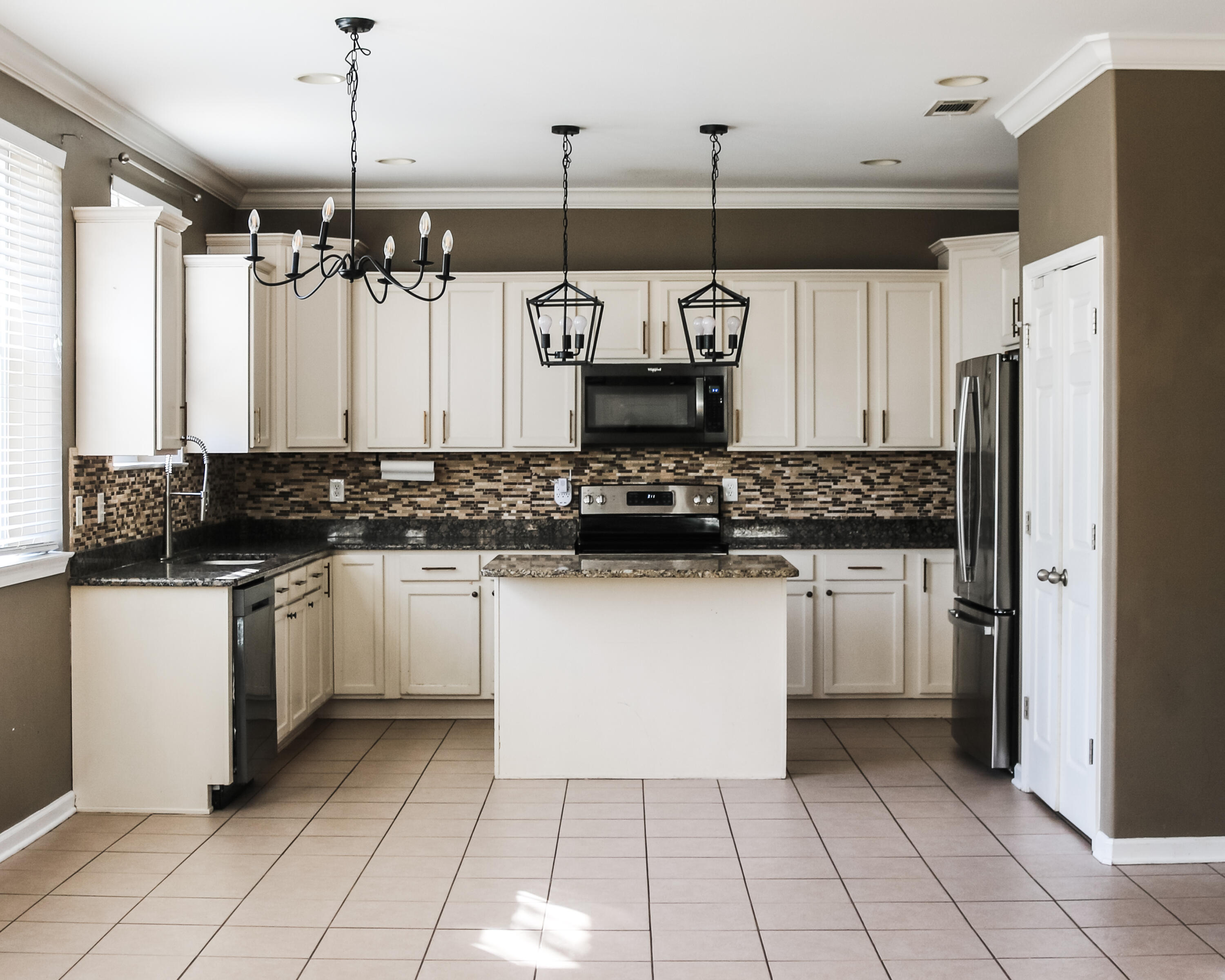 898 Solimar Way Mary Esther, FL 32569 - Photo 6 of 35 a kitchen with stainless steel appliances a refrigerator sink and cabinets