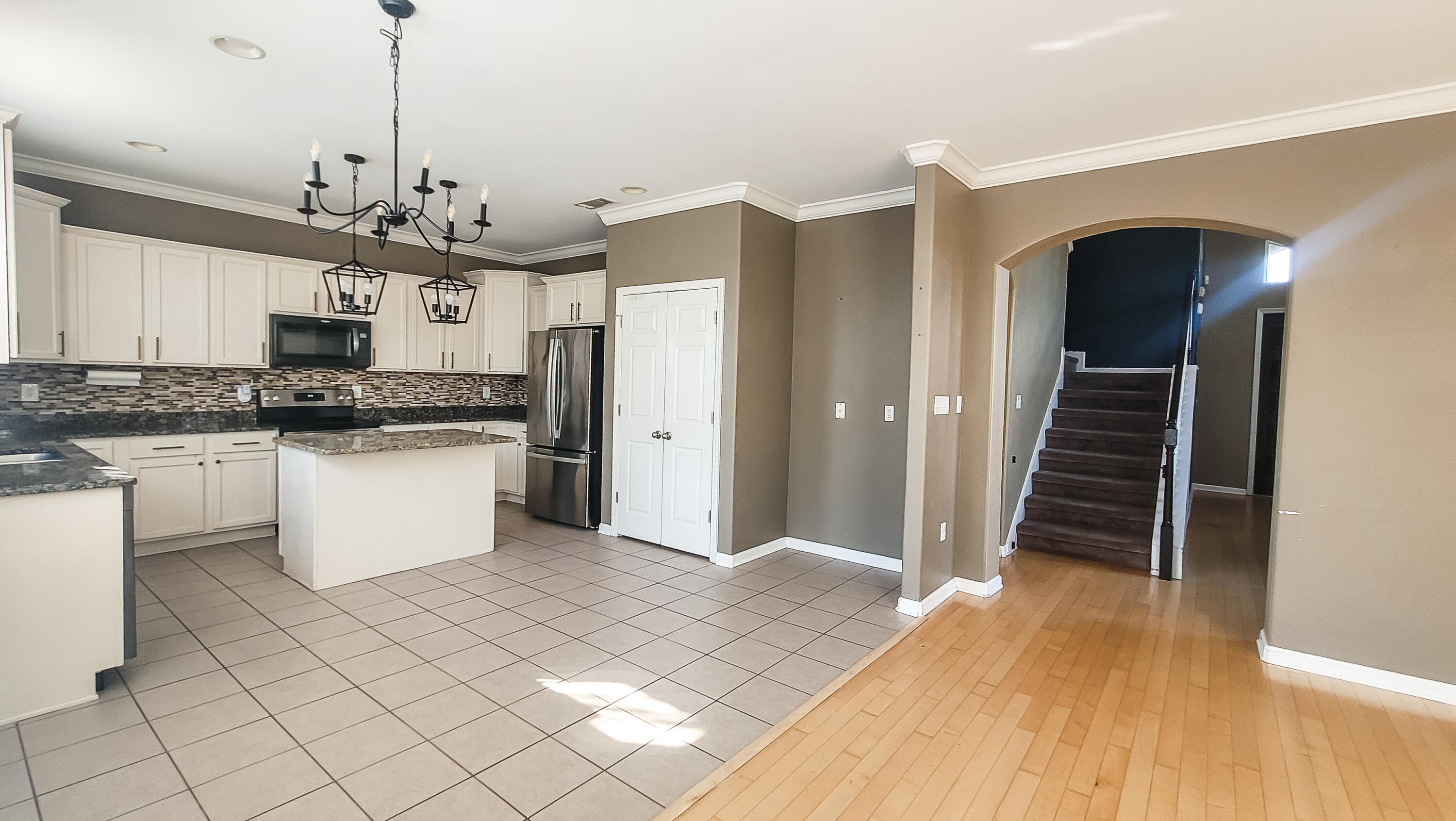 898 Solimar Way Mary Esther, FL 32569 - Photo 9 of 35 a kitchen with stainless steel appliances a stove top oven and cabinets