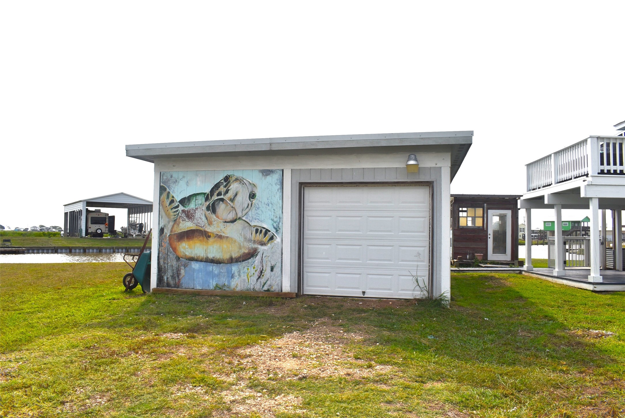 11 Chimaera Street Sargent, TX 77414 - Photo 2 of 43 Detached garage has a big pullup door for parking those toys!