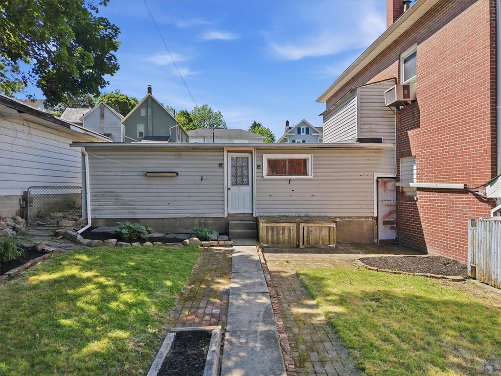 110 Messinger Street Bangor, PA 18013 - Photo 29 of 39 A quaint backyard with a mix of grass and brick pathways offers a private outdoor space.