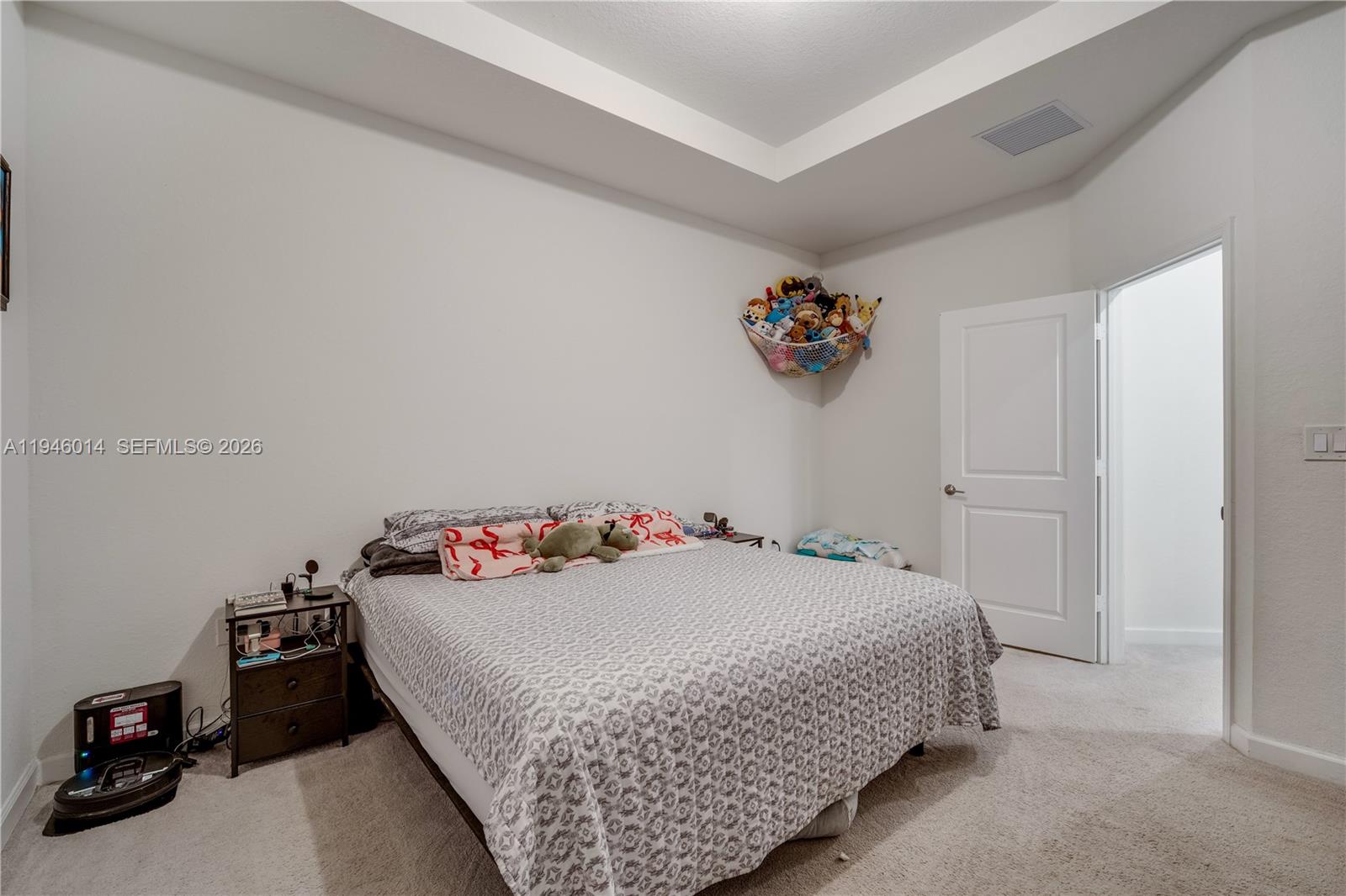 28574 Southwest 134th Court, Unit 28574 Homestead, FL 33033 - Photo 14 of 29 a bedroom with a bed and a window