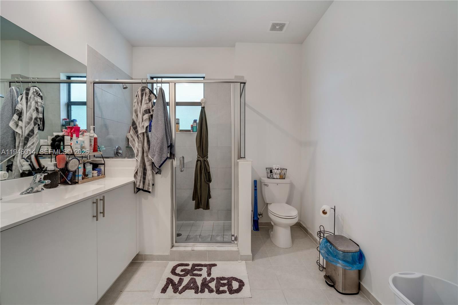 28574 Southwest 134th Court, Unit 28574 Homestead, FL 33033 - Photo 17 of 29 a bathroom with a sink a toilet and shower curtain