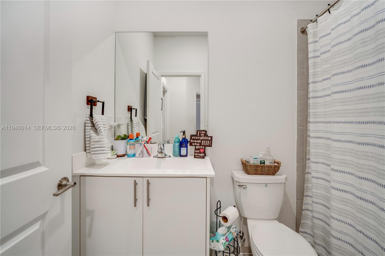 28574 Southwest 134th Court, Unit 28574 Homestead, FL 33033 - Photo 18 of 29 a bathroom with a sink toilet vanity and mirror