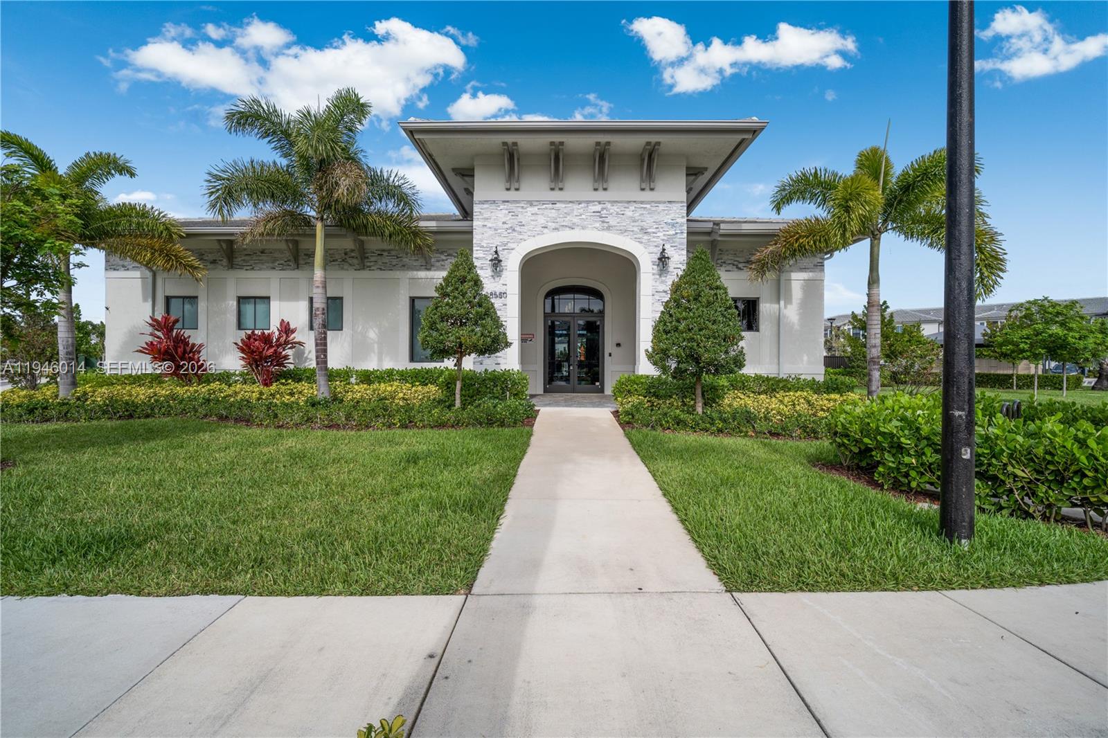 28574 Southwest 134th Court, Unit 28574 Homestead, FL 33033 - Photo 23 of 29 a front view of a house with a yard