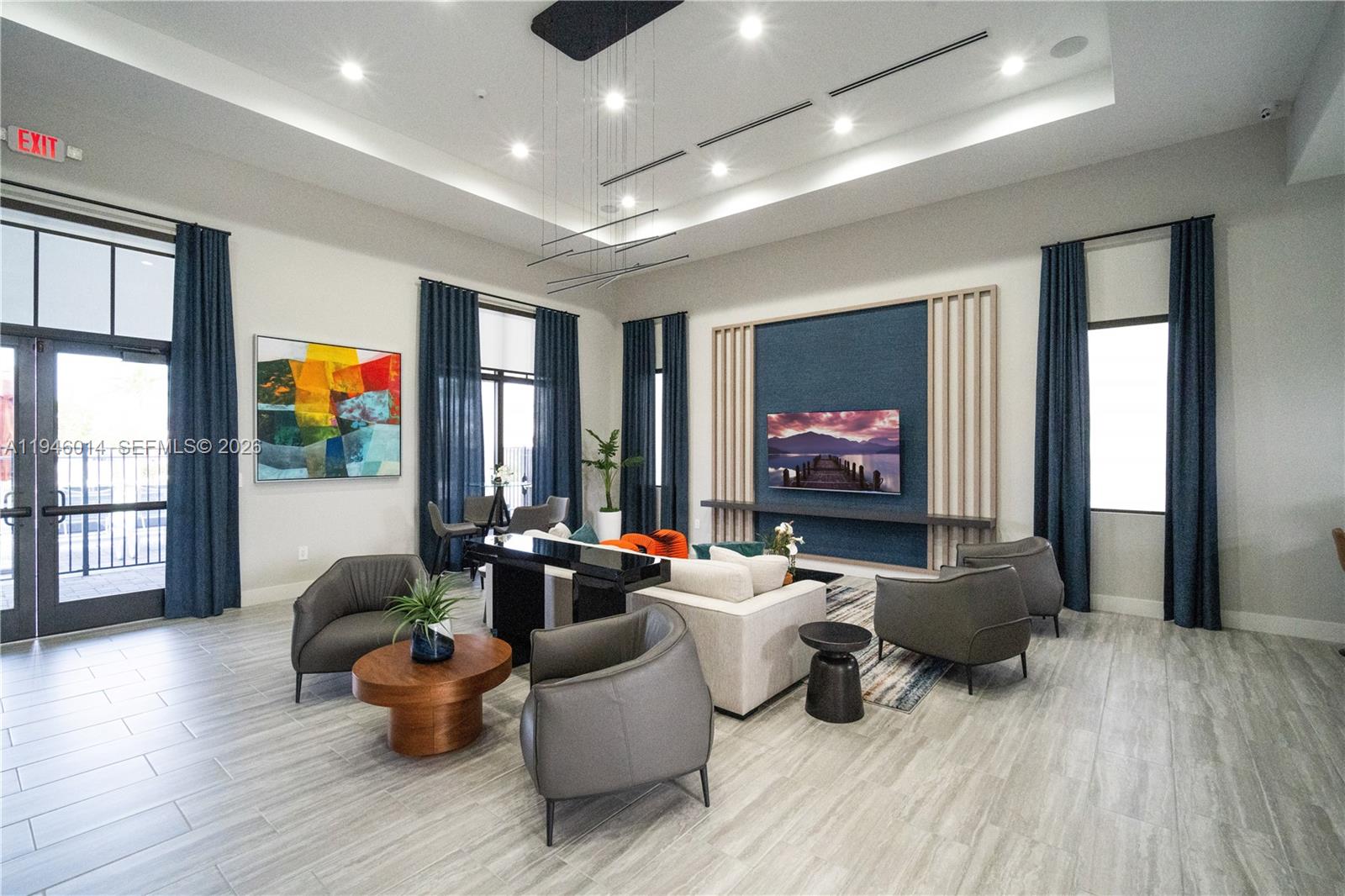 28574 Southwest 134th Court, Unit 28574 Homestead, FL 33033 - Photo 24 of 29 a living room with furniture and a flat screen tv