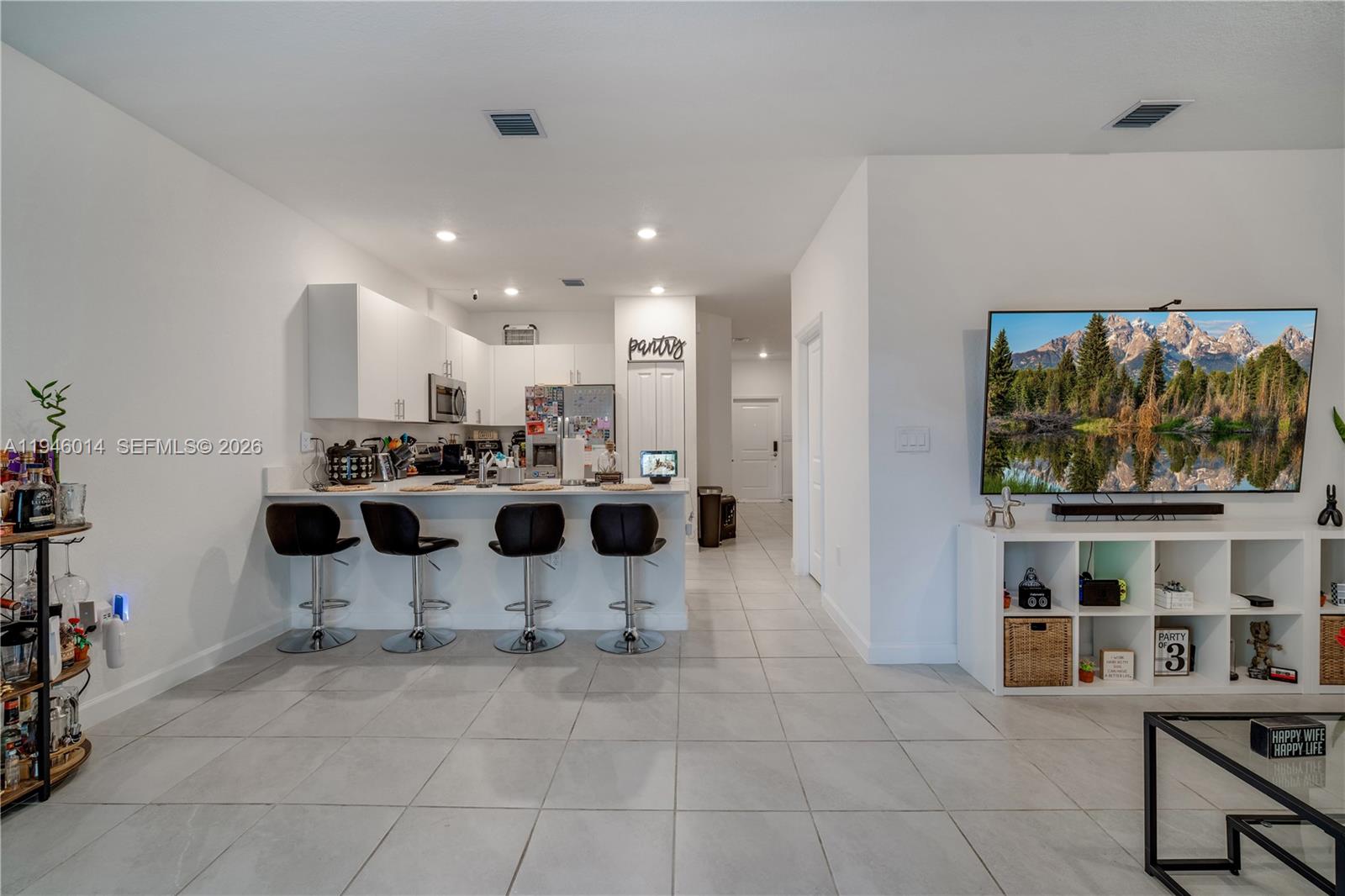28574 Southwest 134th Court, Unit 28574 Homestead, FL 33033 - Photo 7 of 29 a view of kitchen with dining area and windows