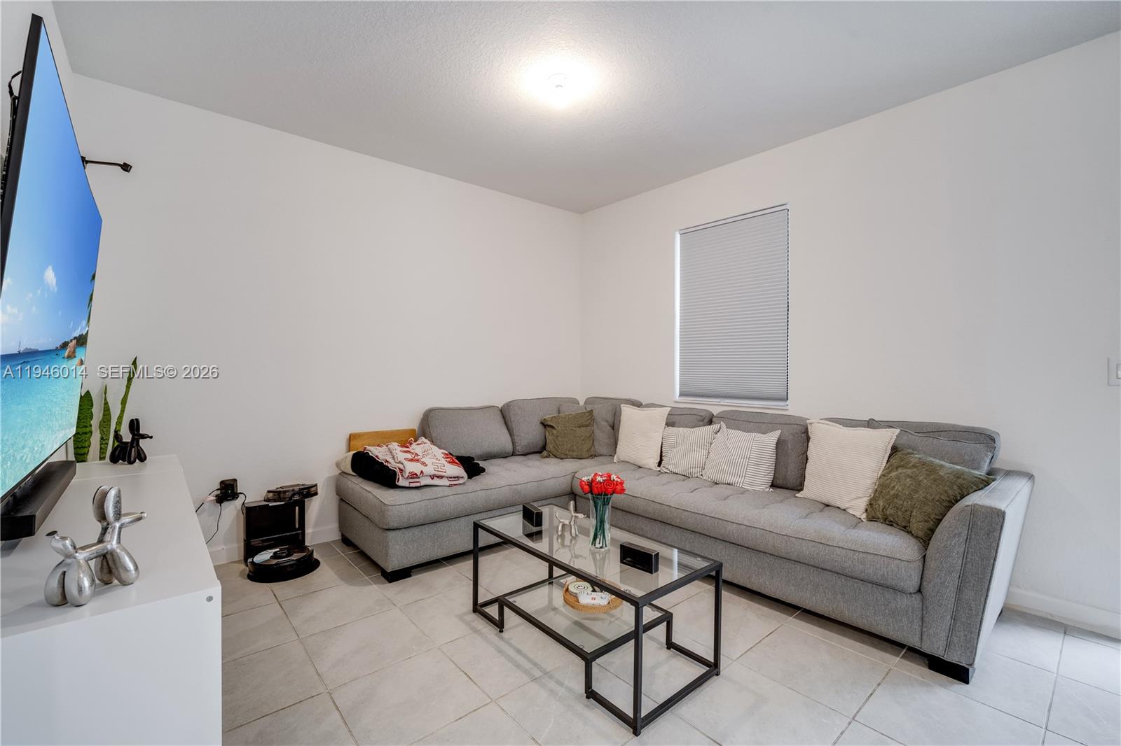 28574 Southwest 134th Court, Unit 28574 Homestead, FL 33033 - Photo 9 of 29 a living room with furniture and a potted plant
