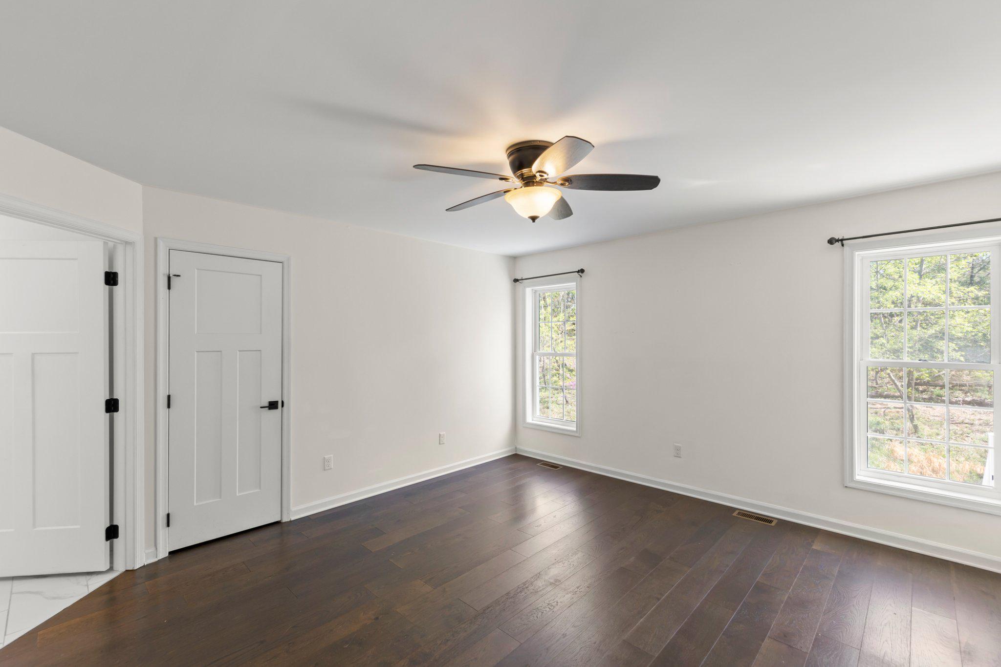 112 Colonial Drive Cross Junction, VA 22625 - Photo 14 of 45 a view of an empty room with a window and wooden floor