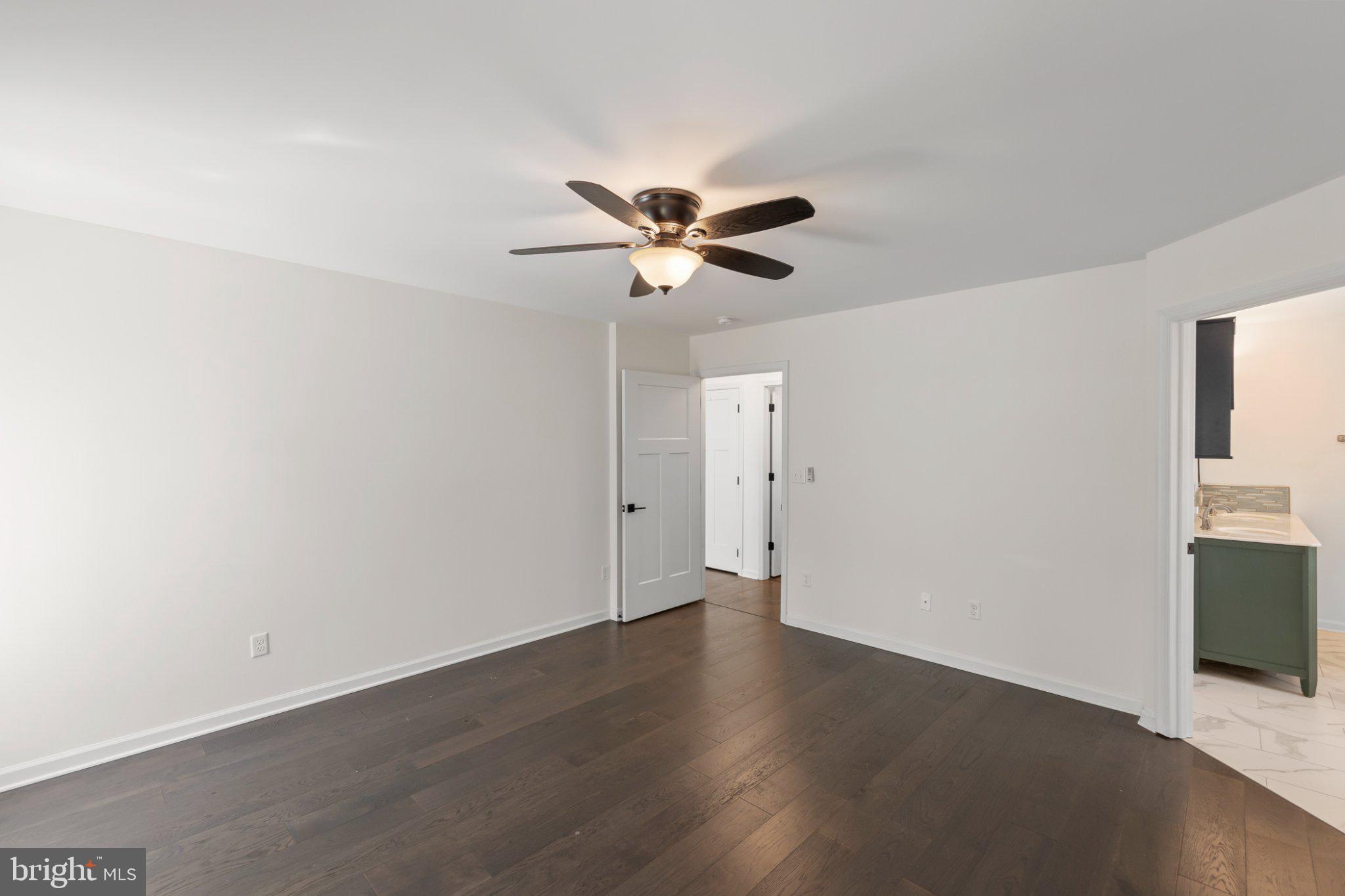 112 Colonial Drive Cross Junction, VA 22625 - Photo 16 of 45 an empty room with wooden floor and a ceiling fan