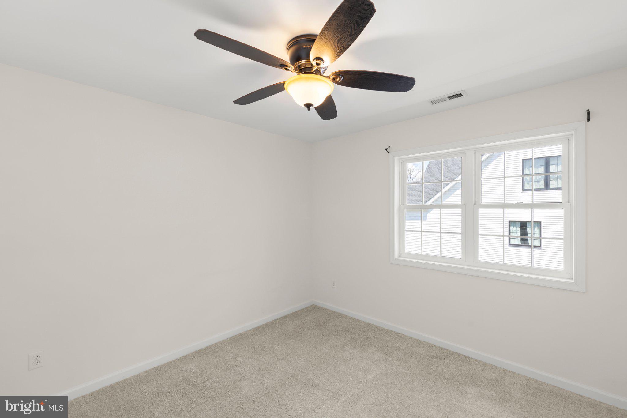 112 Colonial Drive Cross Junction, VA 22625 - Photo 27 of 45 an empty room with window and a ceiling fan