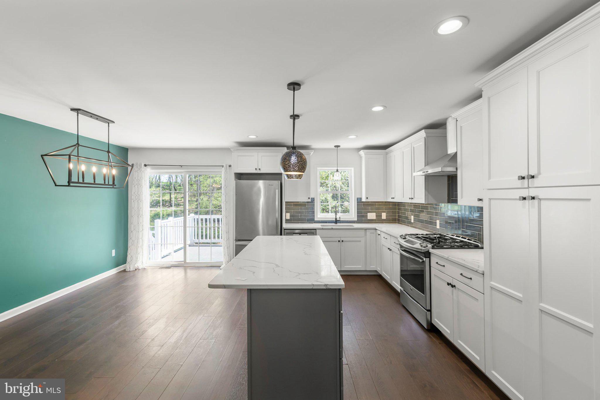 112 Colonial Drive Cross Junction, VA 22625 - Photo 6 of 45 a kitchen with granite countertop a stove a sink dishwasher a refrigerator and white cabinets with wooden floor