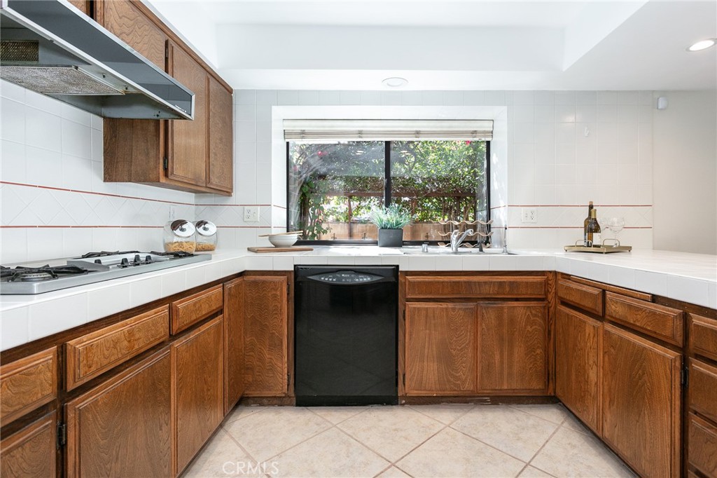 11017 Baird Avenue Porter Ranch, CA 91326 - Photo 11 of 35 a kitchen with a sink stove and cabinets