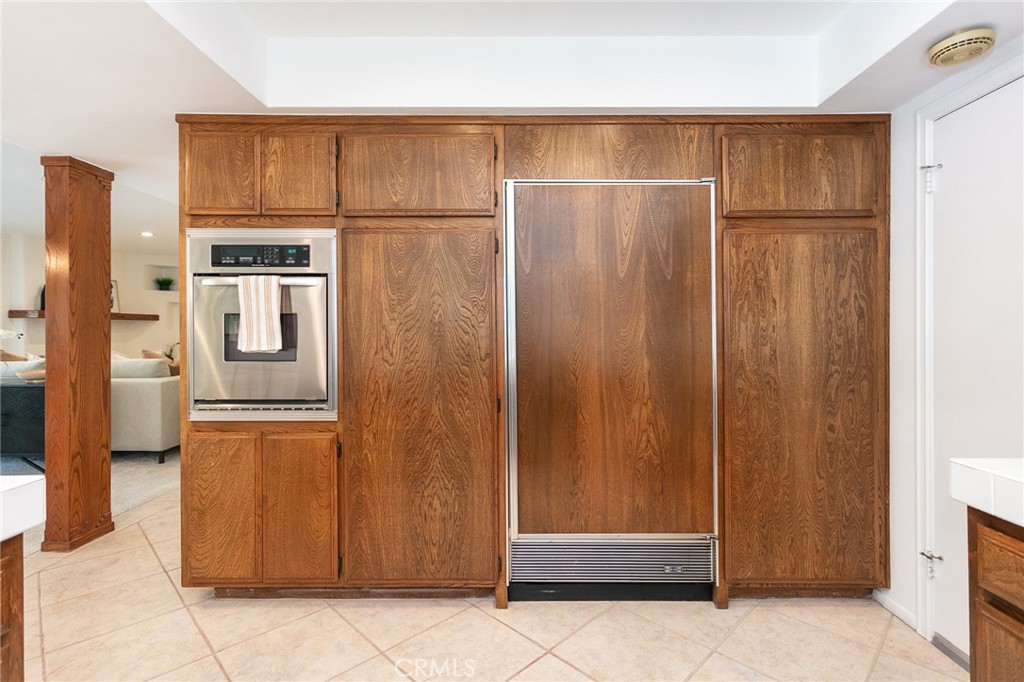11017 Baird Avenue Porter Ranch, CA 91326 - Photo 12 of 35 a view of a refrigerator in kitchen with stainless steel appliances wooden cabinet and refrigerator