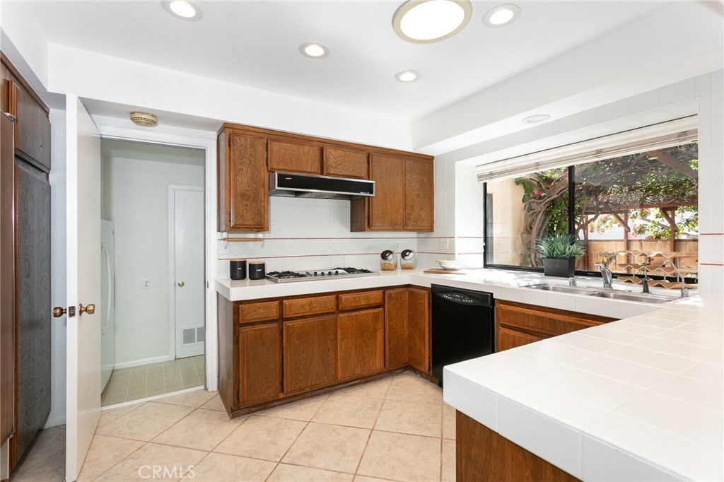 11017 Baird Avenue Porter Ranch, CA 91326 - Photo 13 of 35 a kitchen with stainless steel appliances granite countertop a stove and a sink