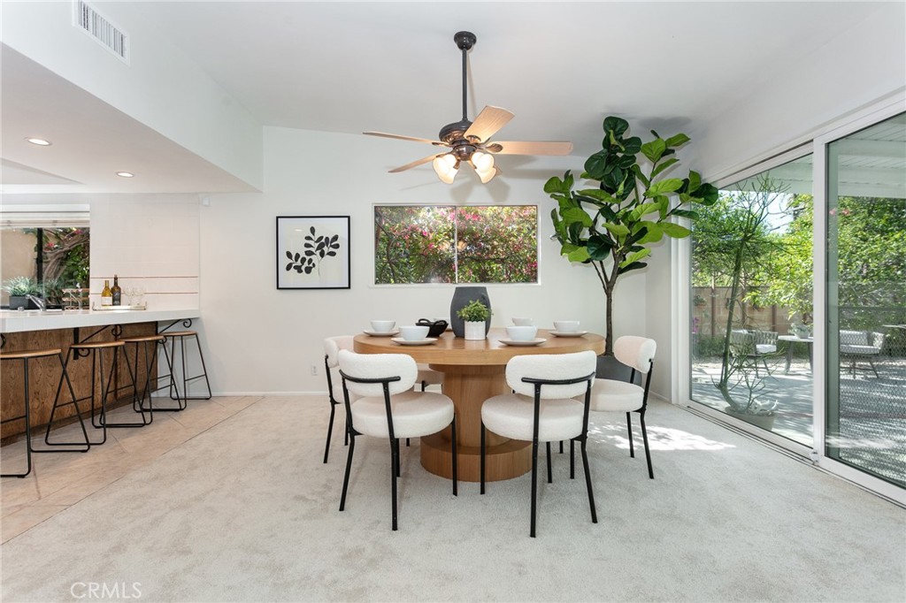 11017 Baird Avenue Porter Ranch, CA 91326 - Photo 14 of 35 a dining room with furniture potted plants and a chandelier