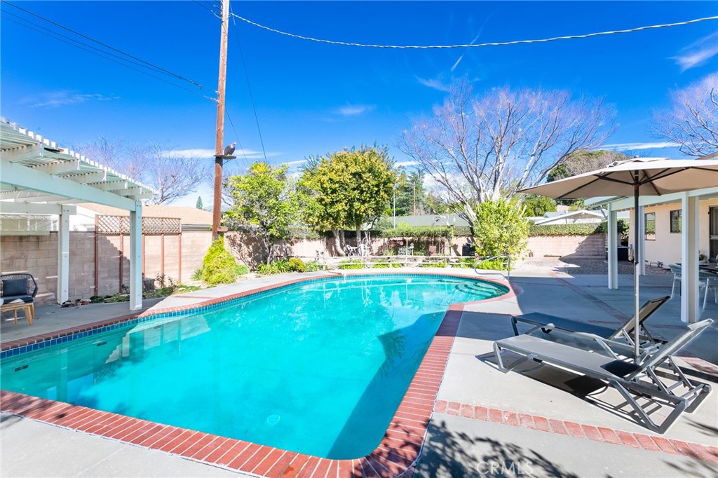 11017 Baird Avenue Porter Ranch, CA 91326 - Photo 16 of 35 a view of a swimming pool with a patio