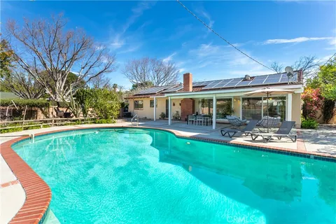a view of a chairs and table in backyard
