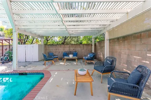a view of a house with swimming pool and sitting area