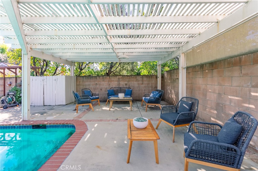 11017 Baird Avenue Porter Ranch, CA 91326 - Photo 18 of 35 a view of a chairs and table in backyard
