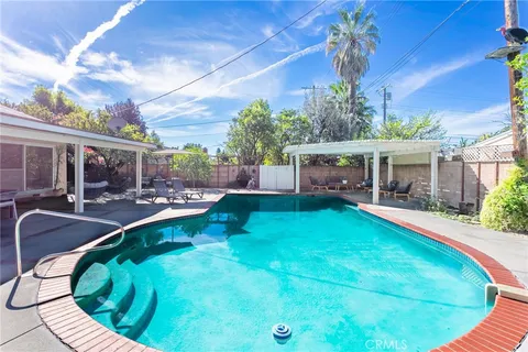 a front view of a house with a tree