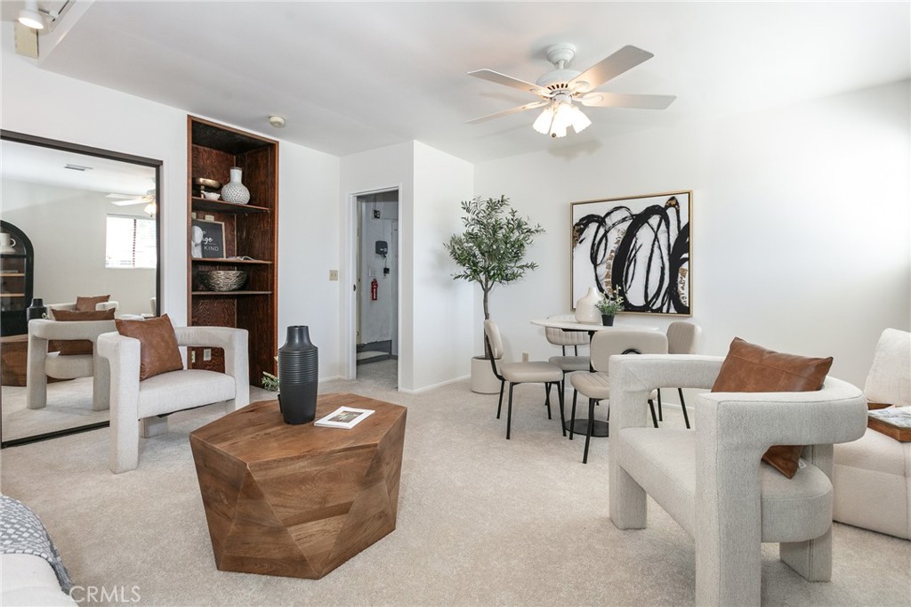 11017 Baird Avenue Porter Ranch, CA 91326 - Photo 22 of 35 a living room with furniture a chandelier and a bookshelf