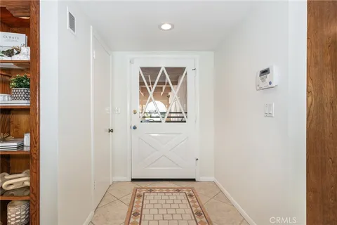 a living room with furniture a clock on wall and a window