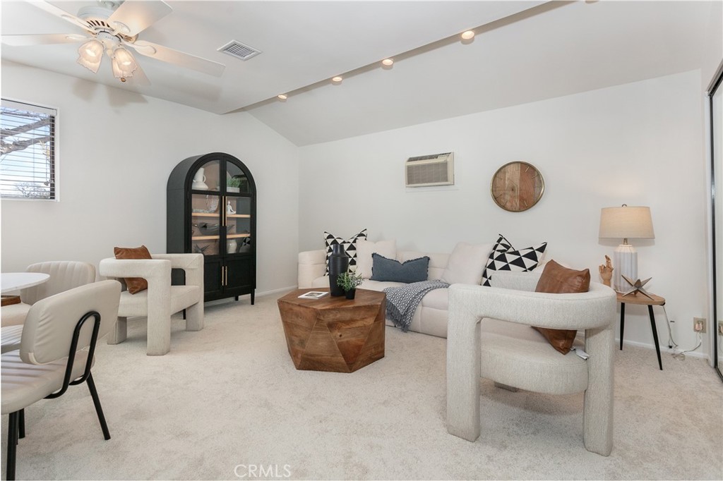 11017 Baird Avenue Porter Ranch, CA 91326 - Photo 25 of 35 a living room with furniture a clock on wall and a window