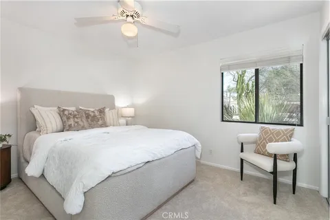 a bedroom with a large bed and a window