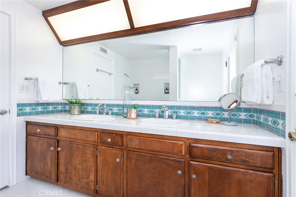 11017 Baird Avenue Porter Ranch, CA 91326 - Photo 31 of 35 a bathroom with a sink and mirror