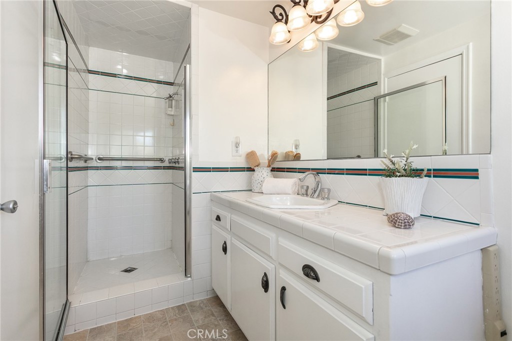 11017 Baird Avenue Porter Ranch, CA 91326 - Photo 35 of 35 a bathroom with a shower sink vanity and mirror
