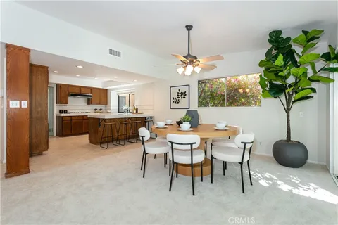 a kitchen with kitchen island granite countertop wooden cabinets and stainless steel appliances