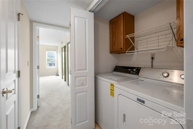 a view of storage and utility room with washer and dryer
