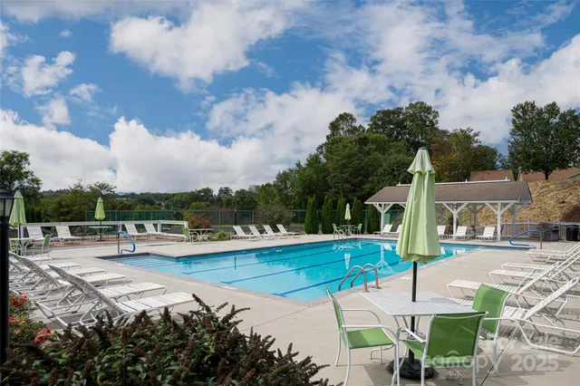an aerial view of a house with swimming pool garden and lake view
