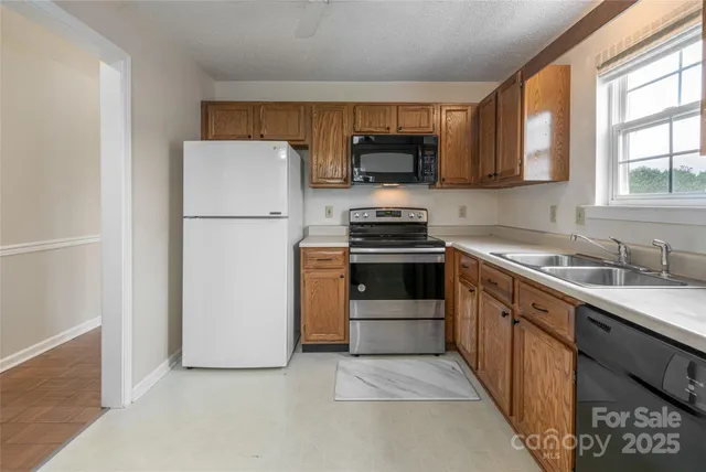 a kitchen with stainless steel appliances a stove sink and microwave