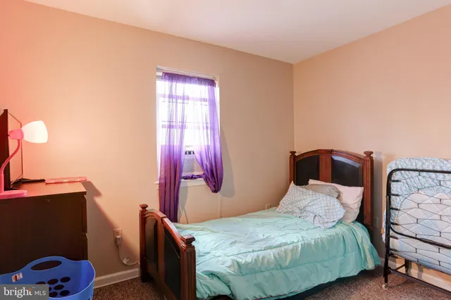 a bedroom with a bed and dresser