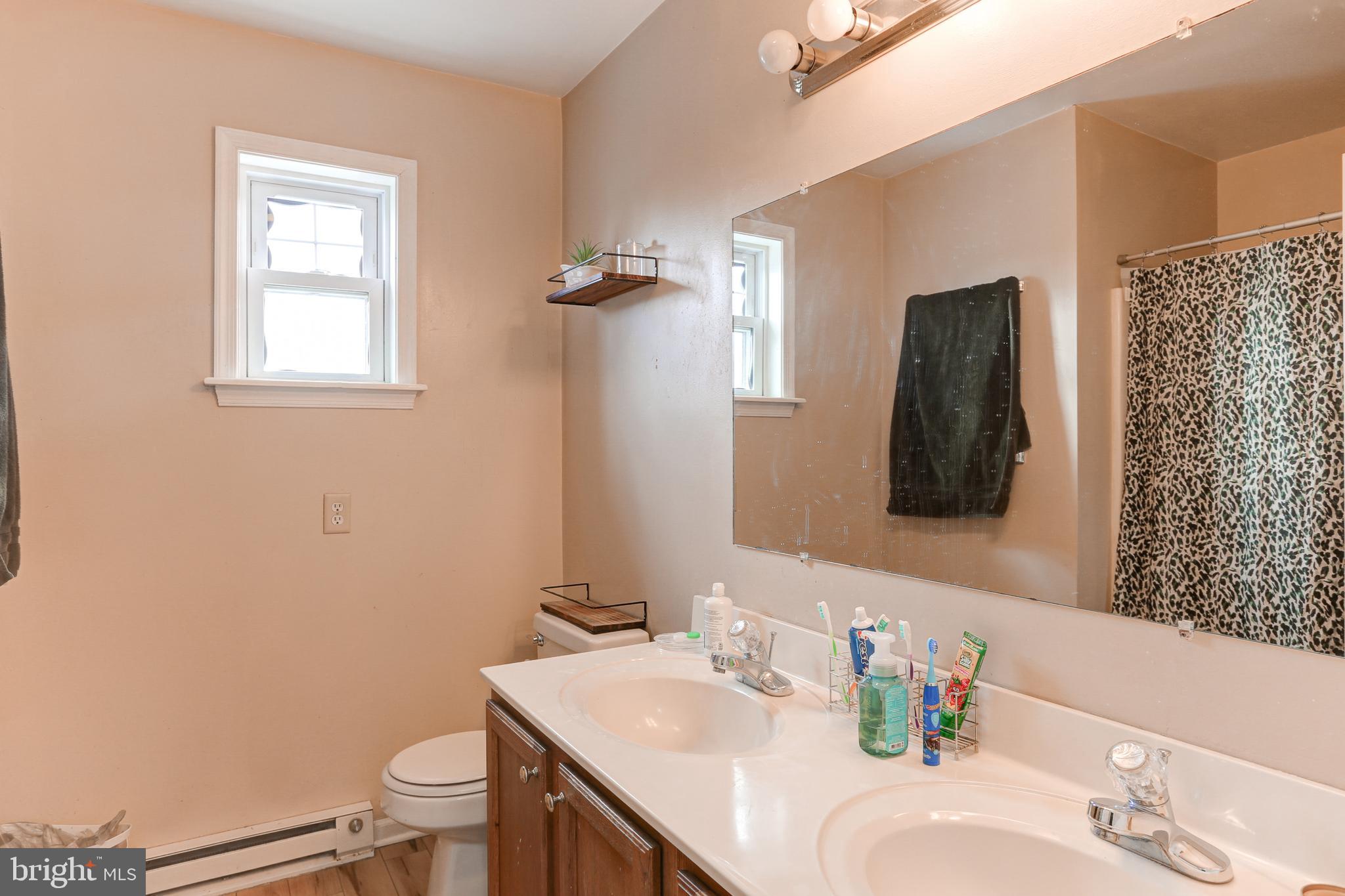 3057 Milky Way Dover, PA 17315 - Photo 9 of 16 a bathroom with a sink toilet and mirror