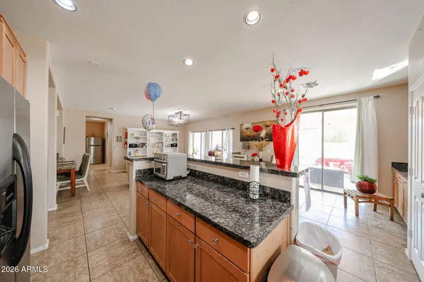 a kitchen with stainless steel appliances granite countertop a stove a sink dishwasher and a refrigerator