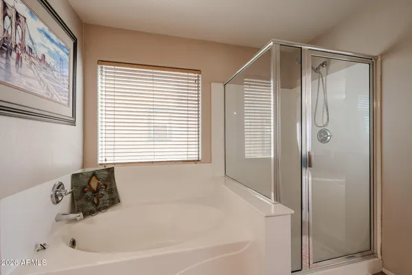 a spacious bathroom with a double vanity sink and a mirror